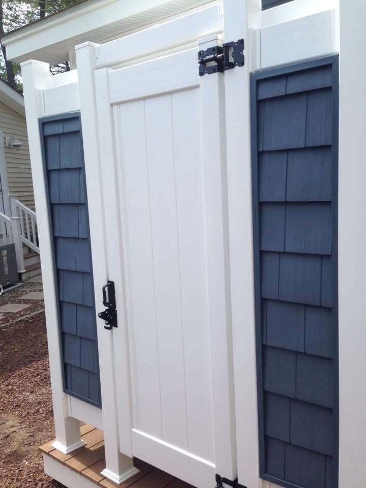 Outdoor Shower with Blue Siding — photograph 1